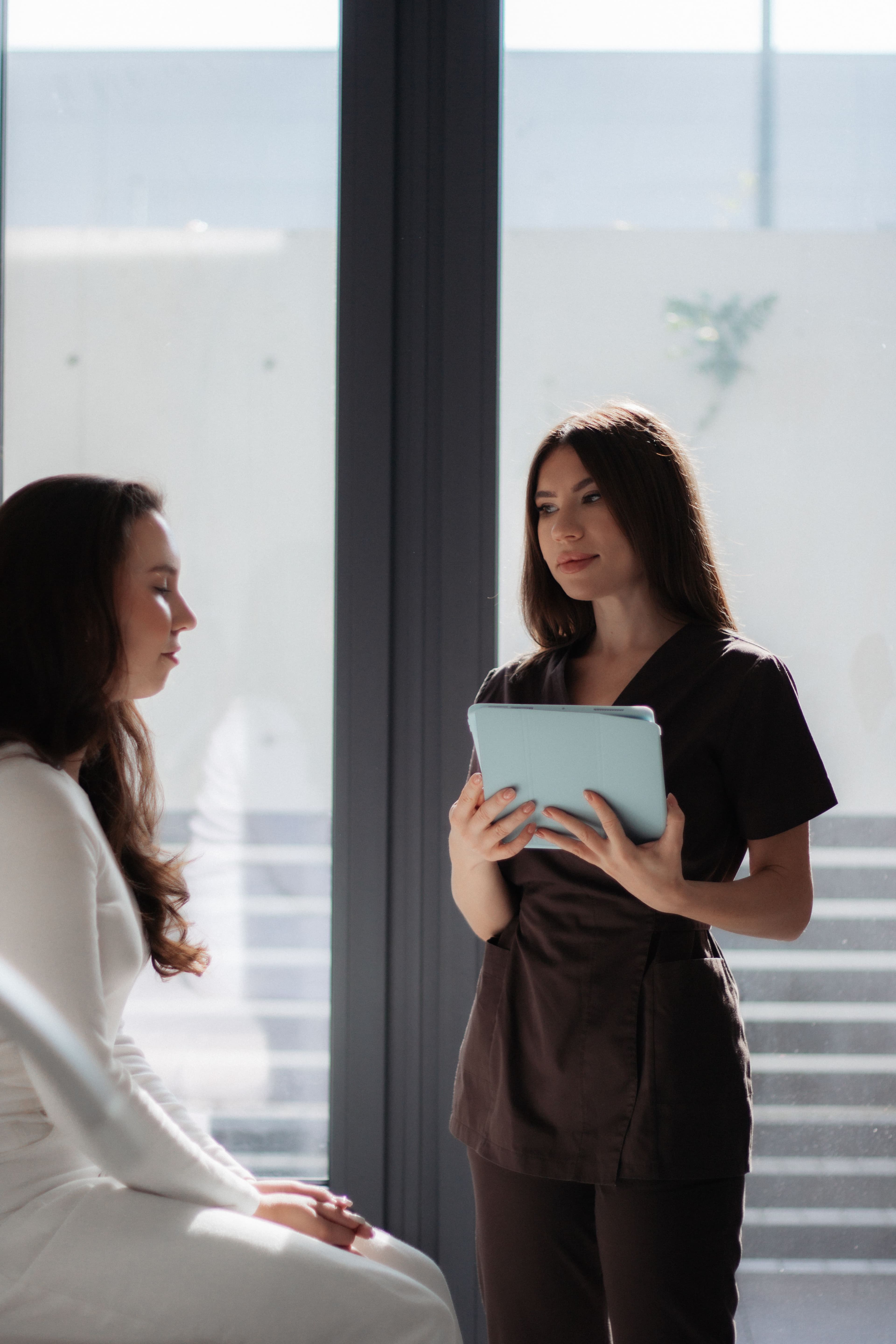 A medical aesthetics provider consulting with a patient